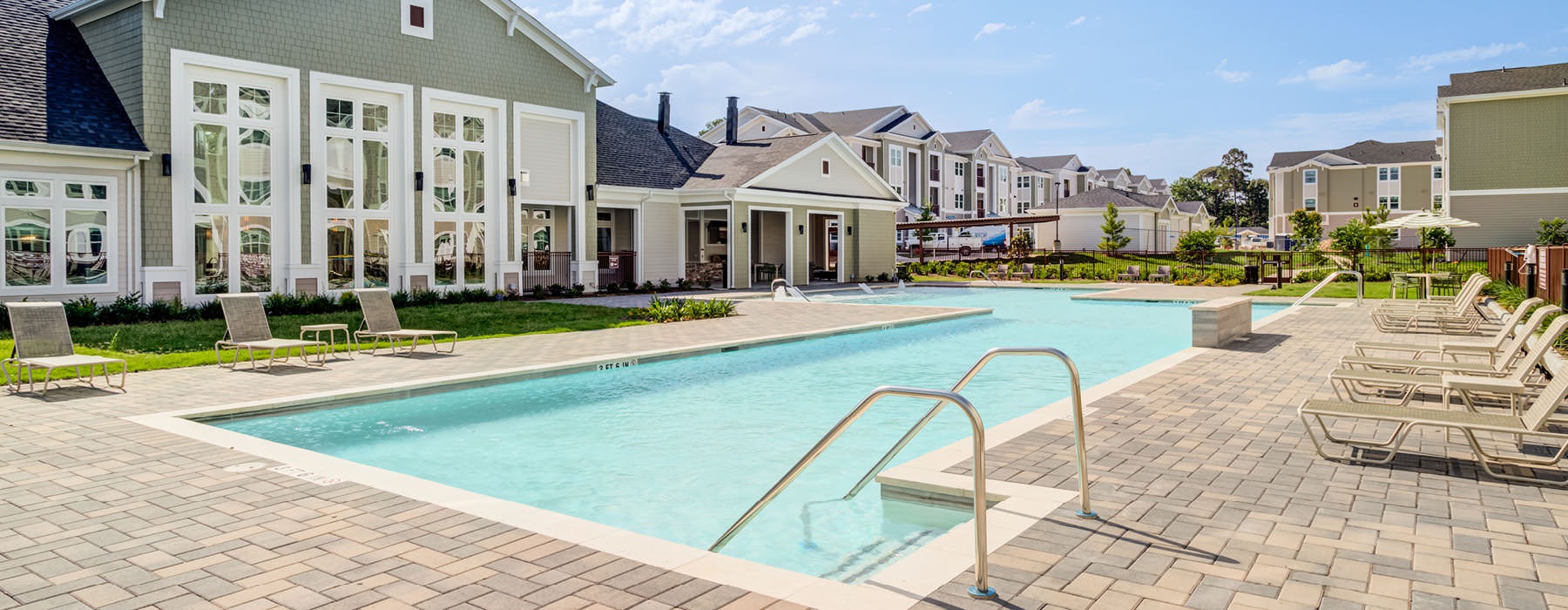 lounge chairs surround swimming pool